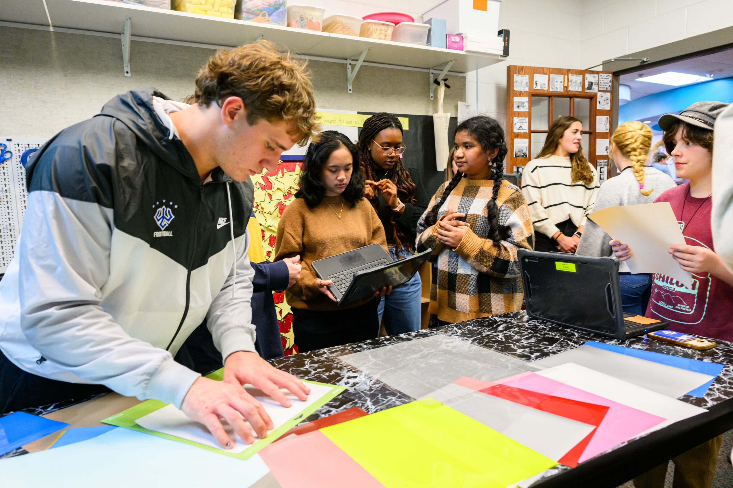Sarah Margalus working with students in the Lylburn Downing Middle School makerspace